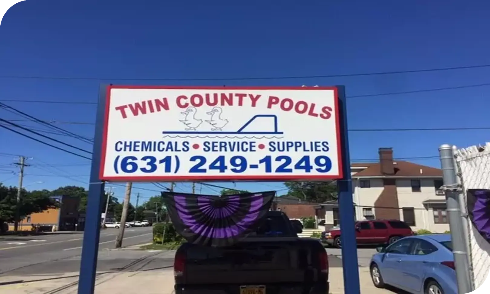 A sign for twin county pools and chemicals.